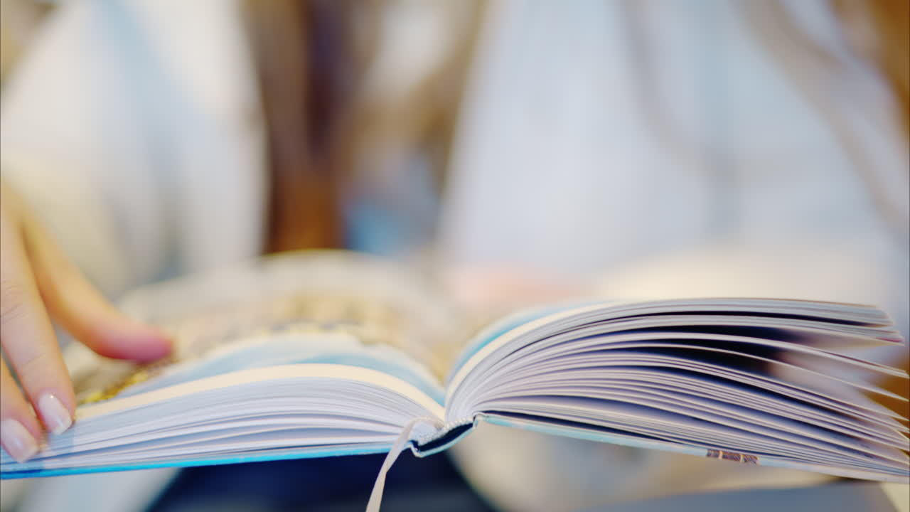Woman reading a book at a coffee shop close up
