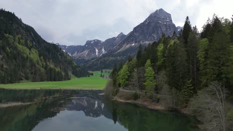 Alpine-lake-Obersee-in-the-Glarus-Alps-and-tourist-area-of-Glarnerland,-Näfels,-Canton-of-Glarus,-Switzerland--drone-shot