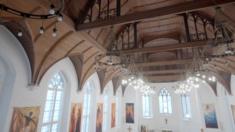 interior of a historical church with wooden ceiling and stained glass windows