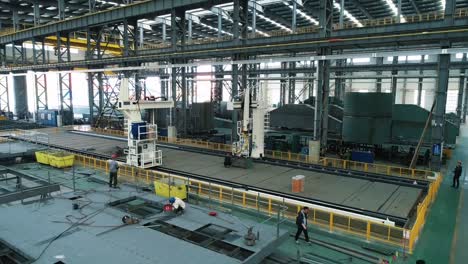 large-scale metal fabrication and assembly in an industrial factory