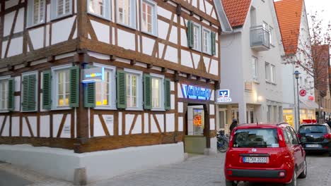 european town street with half-timbered houses and bank