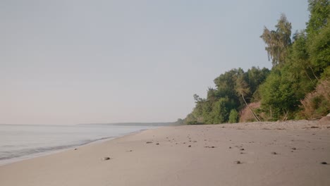 knäbäckshusen beach in the morning with ocean waves in the summer morning, österlen south sweden skåne, wide shot handheld