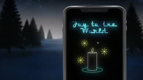 animation of joy to the world text on smartphone over winter scenery at christmas