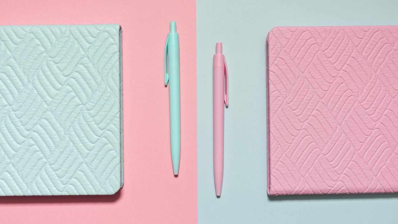 Stop motion of pastel notebooks and matching pens on a pink and blue split set, loopable and symmetric