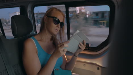 girl with touch pad traveling by car