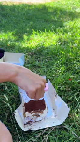 enjoying tiramisu in a park