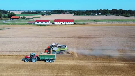 aerial shot of combine loading off corn grains into tractor trailer-6