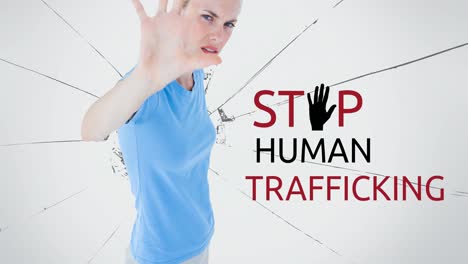 Animation-of-stop-human-trafficking-text-over-caucasian-woman-with-stop-gesture
