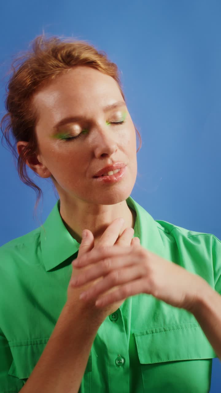 Portrait of a woman with red hair in a green shirt