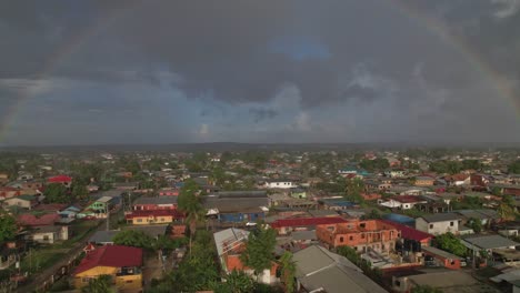 Drohne-Fliegt-über-Dorf-In-Richtung-Regenbogen