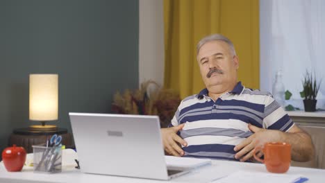 home office worker old man looking smugly at camera.