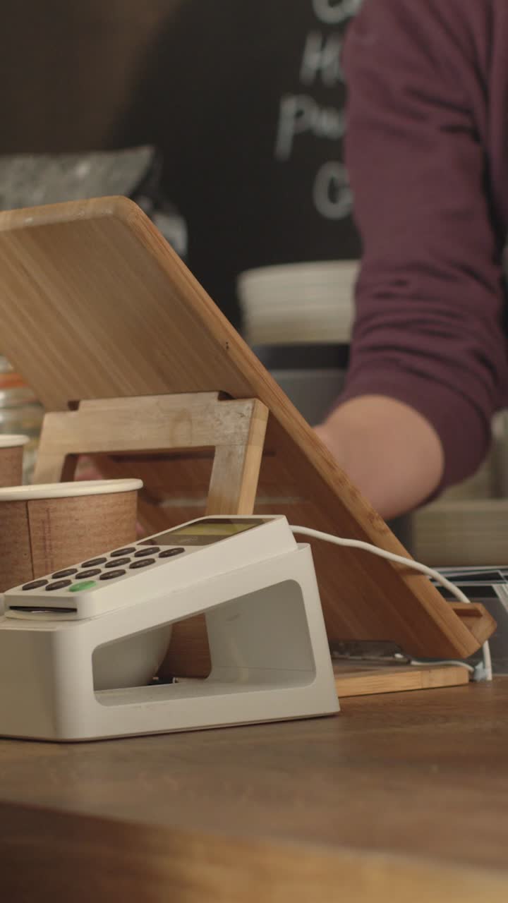 Woman Paying for Coffee Using Contactless