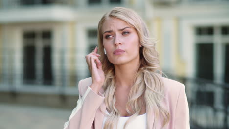 portrait woman talking by wireless headset. girl using wireless earbuds