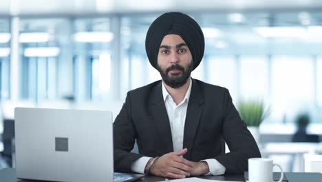happy sikh indian businessman saying hello