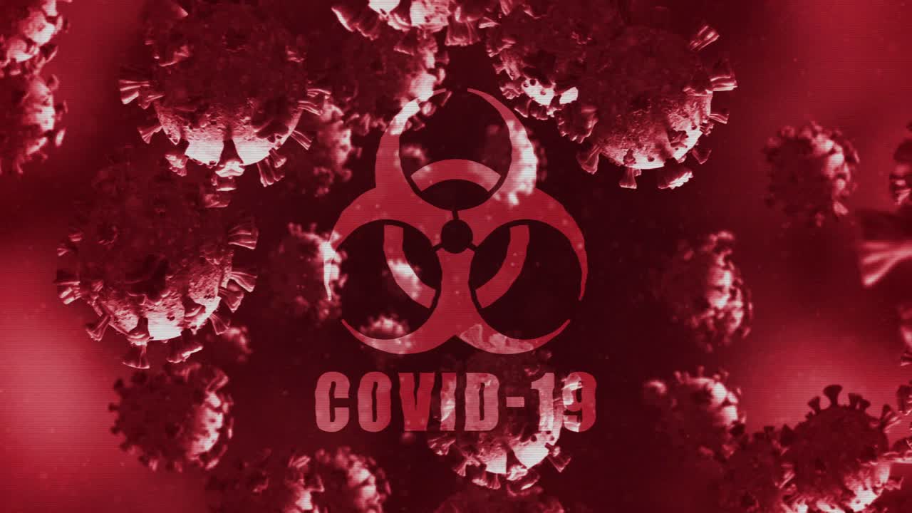 Animation of a word Covid-19 with a health hazard sign over Coronavirus cells floating in a liquid 4