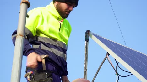 close up shot of labor screwing screw into solar panel fixation set