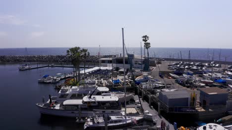 Aerial-close-up-panning-shot-of-the-King-Harbor-Yacht-Club-in-Redondo-Beach,-California