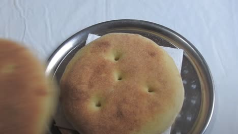 male hands serving moroccan bread for lunch. morocco