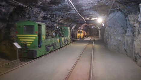 driving on railway tracks that run underground in the tunnels of a mine.