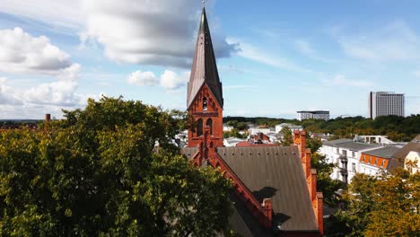 Iglesia-En-Un-Pequeño-Pueblo,-Maravilloso-Cielo-Azul,-Warnemünde,-Drone