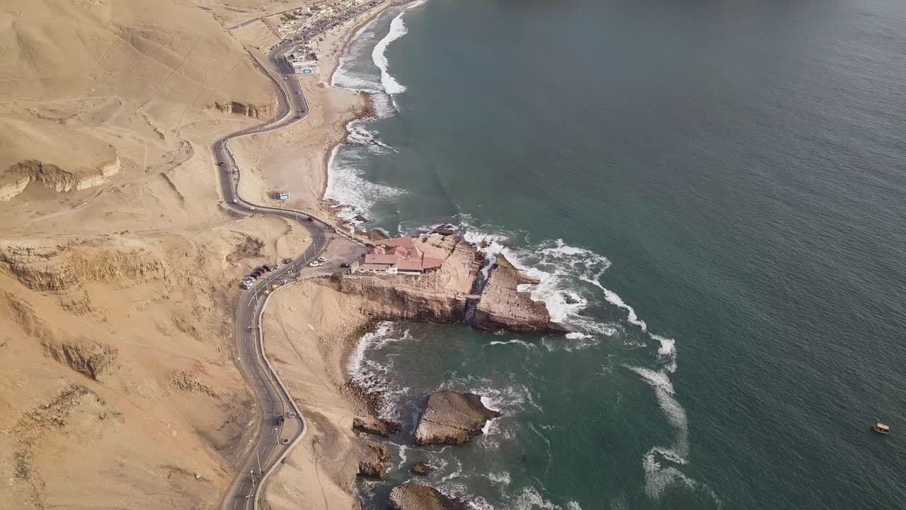 Stunning aerial shot showcasing rugged coastal cliffs, a winding road, and powerful ocean waves. Perfect for travel blogs, wall art, or real estate marketing. Leap of the Friar.