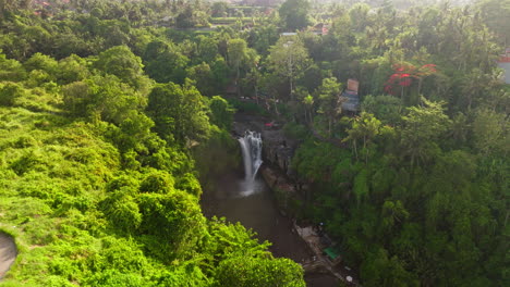 tegenungan waterfall in bali ubud forest. aerial circling