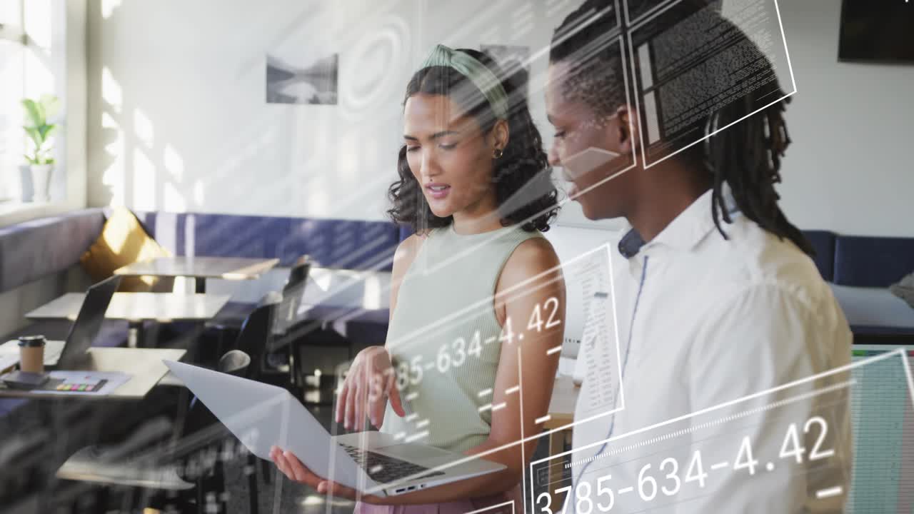 Woman tilting laptop screen and pointing chart as man leaning in with overlays updating tech data
