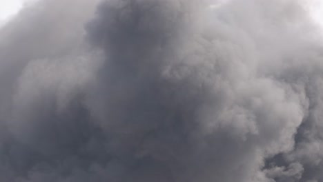 thick, dark smoke clouds billow intensely, filling the frame with dynamic movement and dramatic atmosphere