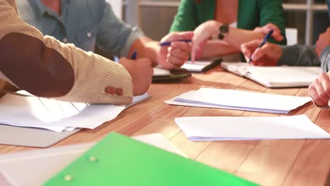 casual business team taking note during meeting