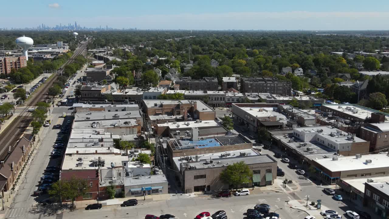 La Grange, IL on a sunny fall day, showcasing streets, buildings, and the suburban landscape With Downtown Chicago in Background. Crane Up Left Zoom x1 Day E