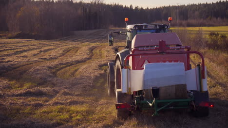 Harvester-machines,-harvesting-on-a-wheat-field,-on-the-countryside,-on-a-sunny-day,-in-Soderhamn,-Sweden