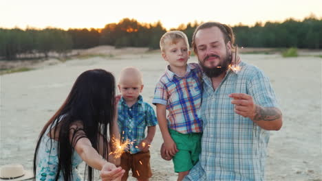 happy family playing with children - burning sparklers