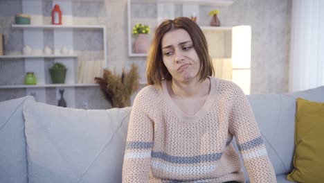 sad thoughtful young single woman pensive sitting alone at home. boredom.