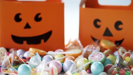 halloween box with various candies on white background 4k