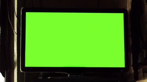 tv set with green screen mounted on a wall inside a historic cafe (known as "bare notable"), in buenos aires. 4k resolution.