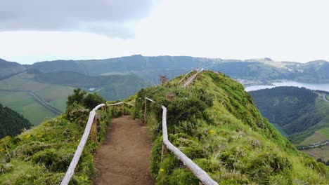 walking on hiking trail boca do inferno in sete cidades crater massif, azores