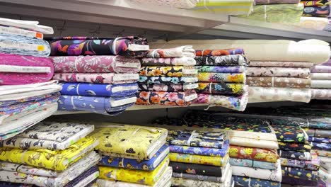 stacks of colorful fabrics on shelves
