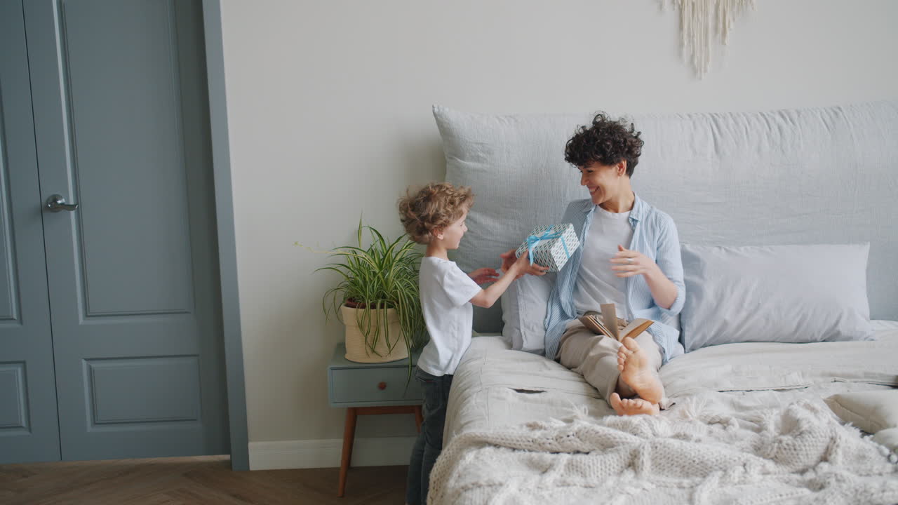 Mother and Son Sharing a Gift and Reading