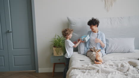 mother and son sharing a gift and reading