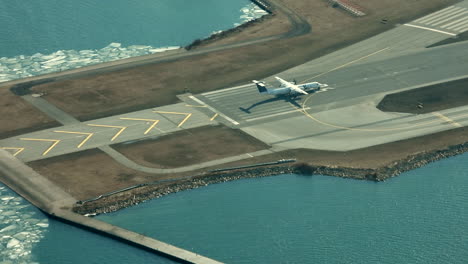 Small-airplane-with-propellers-taking-off-on-a-Billy-Bishop-Toronto-City-Airport