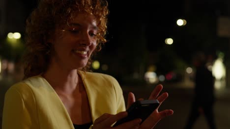 woman using phone at night