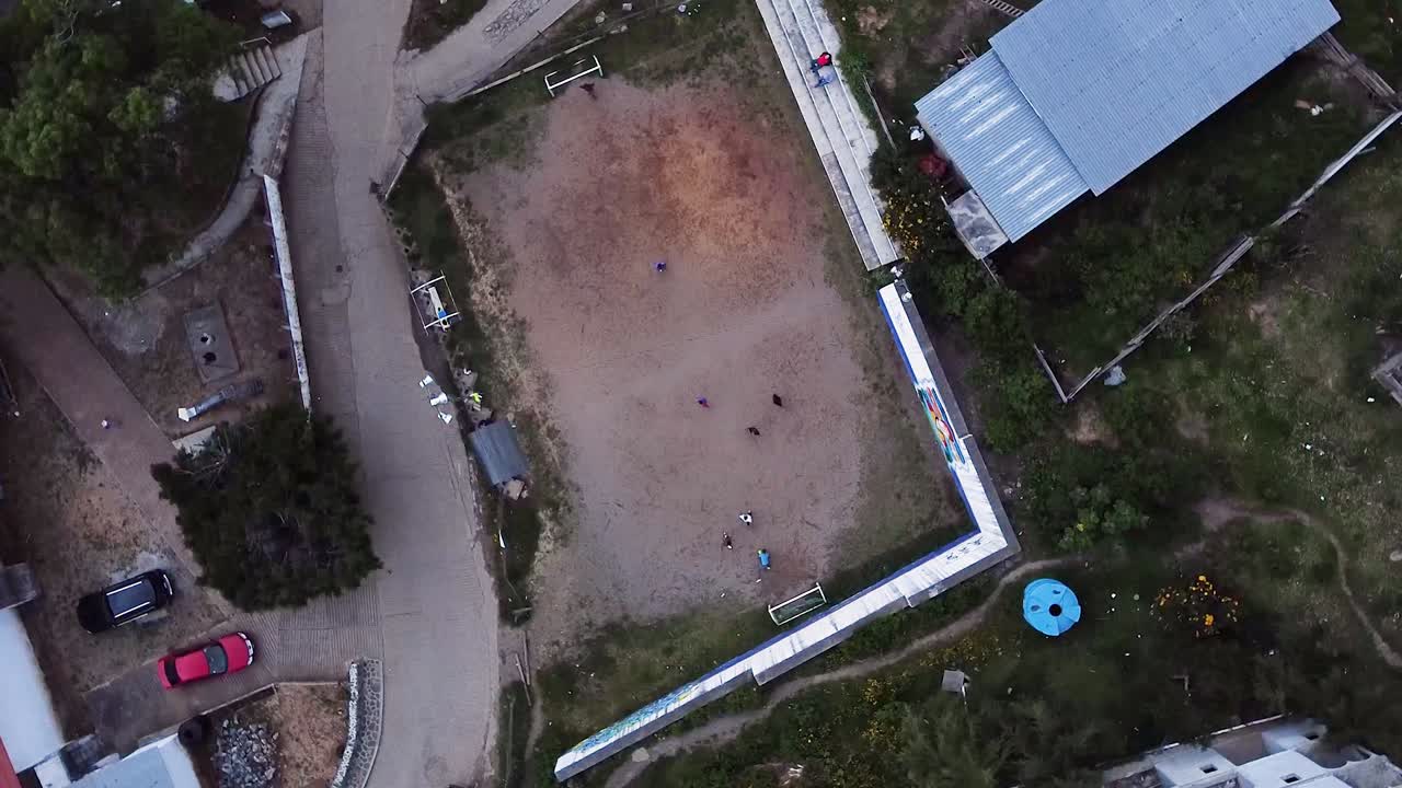 멕시코 오아카사 (oaxaca) 에서 축구를 하는 아이들과 함께 시골 마을 위를 안정적으로 비행하는 드론