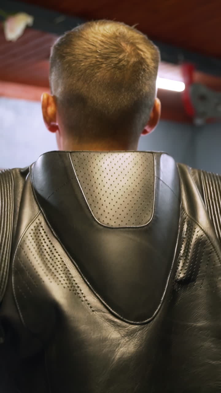 Man wearing a black leather motorcycle jacket