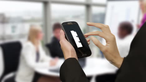 Businesswoman-using-smart-phone-in-meeting