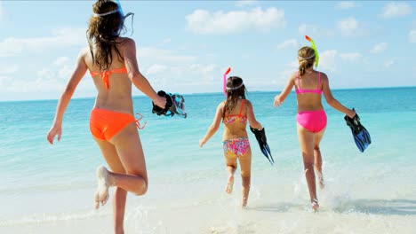 caucasian girls in colorful swimwear snorkeling from beach