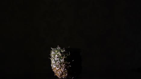 fading disassembling pineapple, ananas in the dark