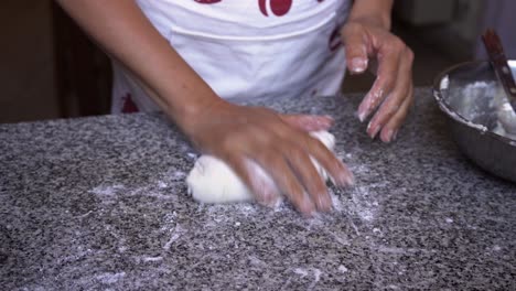 Experienced-female-pastry-chef-kneading-homemade-dough