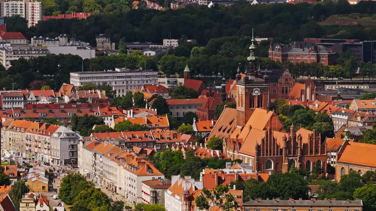 Telephoto shot of Gdańsk old town, red rooftops and historic cathedral towers