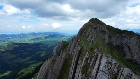 4k drone aerial shot of slated rock peaks at shäfler ridge in appenzell region of switzerland