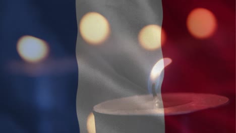 bandera francesa con una vela apagándose